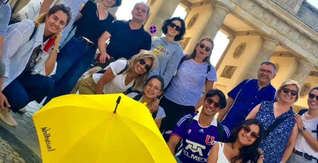 Happy tourists on a WALKATIVE! tour in front of Berlin's Brandenburg Gate.
