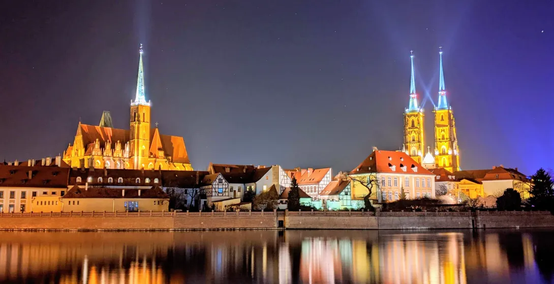 Night view of Wroclaw's Cathedral Island, reflecting in the Oder River.