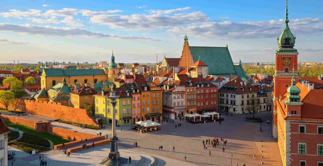 Aerial view of Warsaw Old Town Square with Sigismund's Column, colorful tenement houses, St. John's Archcathedral, and Royal