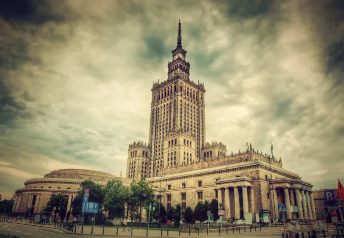 The Palace of Culture and Science in Warsaw under a dramatic sky.