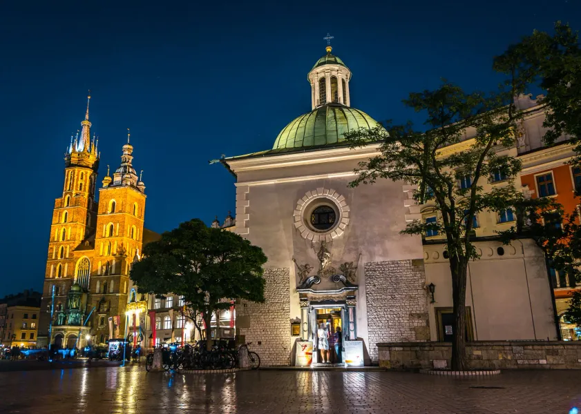 Night view of St. Mary's Basilica and St. Wojciech's Chapel in Krakow's Main Market Square.
