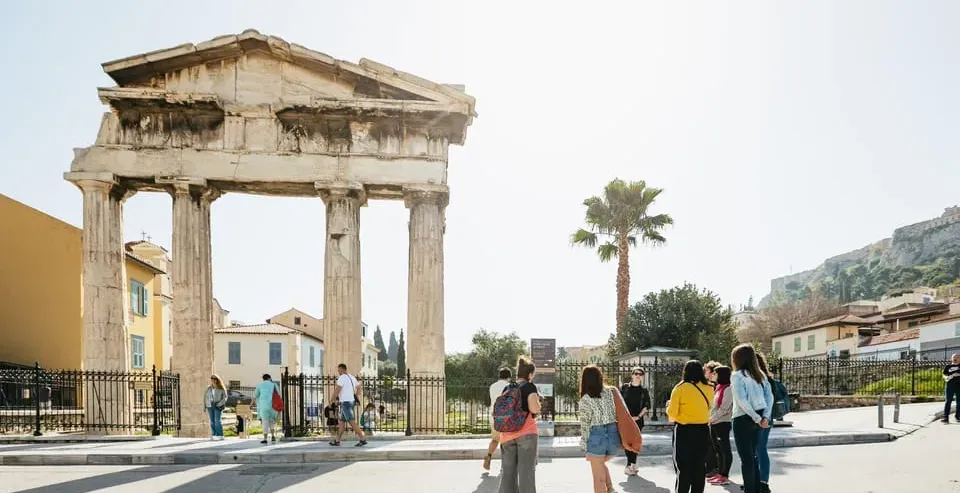 Tour group exploring the ancient Temple of Hephaestus in Athens, Greece.