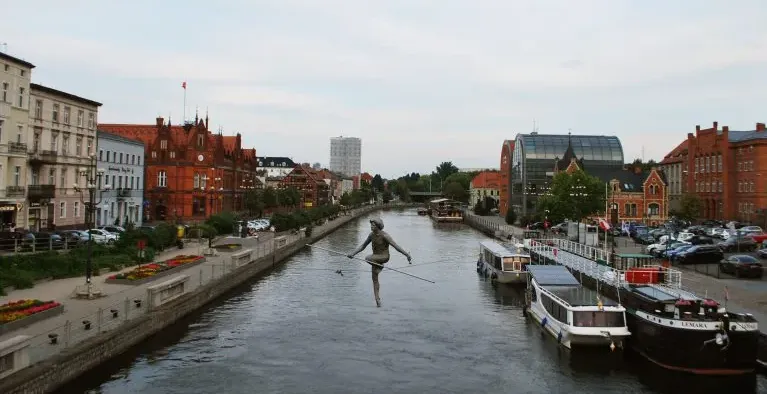 A statue of a tightrope walker over the Brda River in Bydgoszcz, Poland.