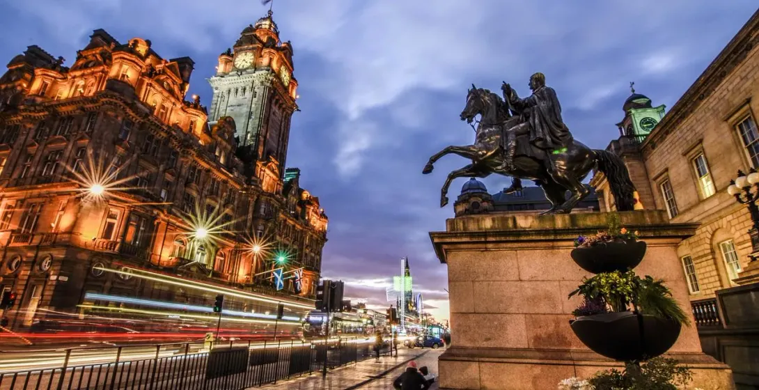 Edinburgh Old Town at night: Balmoral Hotel and King George IV statue.