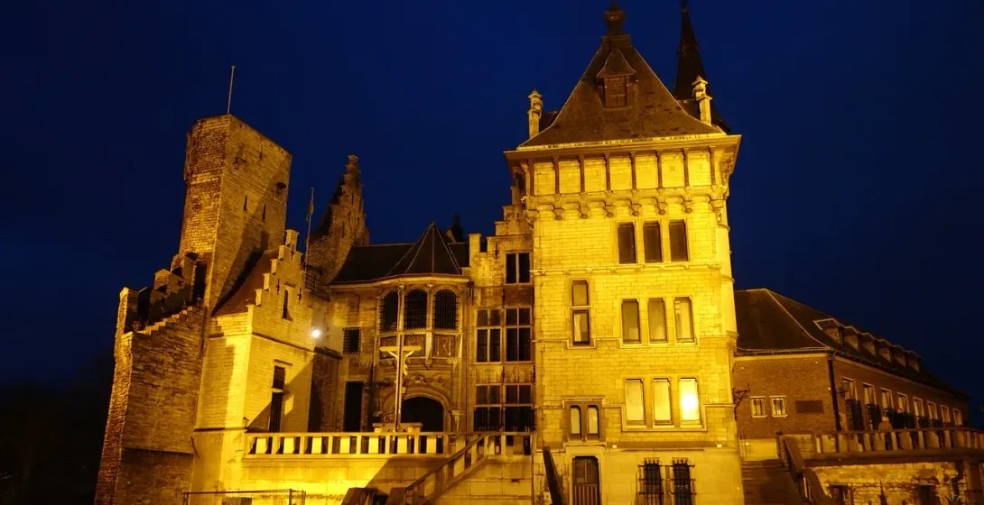 Gravensteen Castle in Ghent, Belgium, illuminated at night.