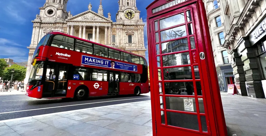 Iconic London scene: red bus, phone booth, and St. Paul's Cathedral.