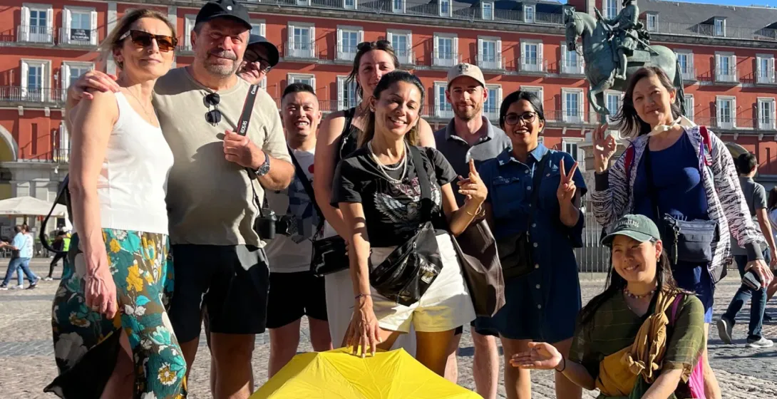 Happy tourists on a WALKATIVE! tour in Madrid's Plaza Mayor.