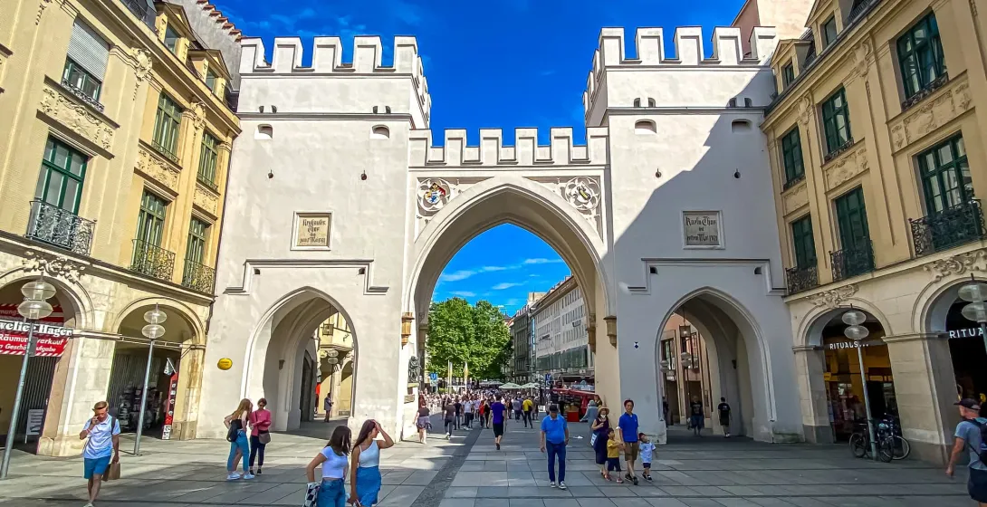 Tourists exploring the historic Karlstor in Munich, Germany.