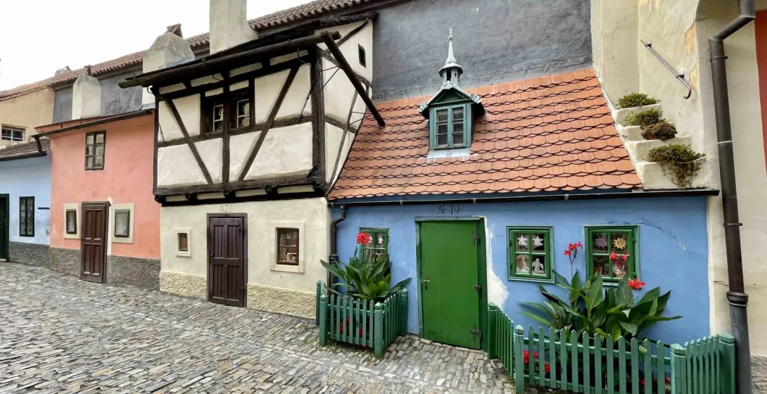 Charming street in Prague Castle with colorful historic houses.