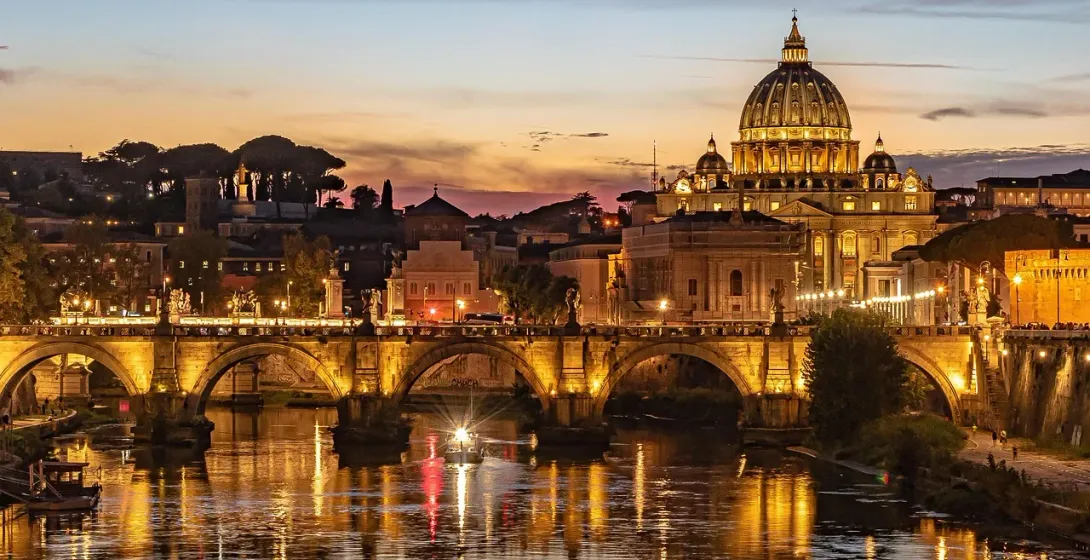 Stunning sunset view of St. Peter's Basilica and Ponte Sant'Angelo in Rome.