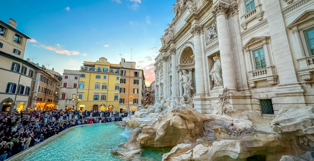 Tourists admiring the Trevi Fountain in Rome during a guided walking tour.