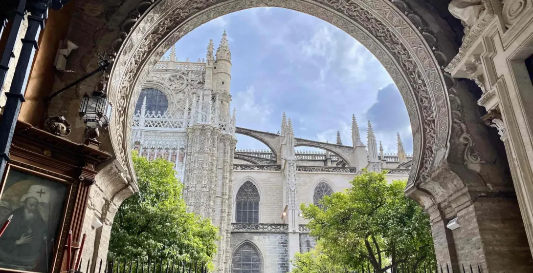 Stunning view of Seville Cathedral through an ornate archway.