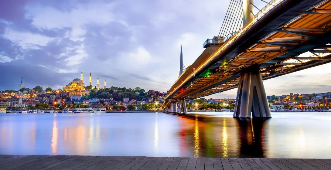 Istanbul cityscape with Halic Metro Bridge at dusk.
