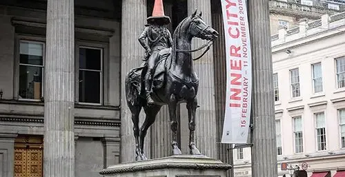 The Duke of Wellington statue in Glasgow, Scotland, wearing a traffic cone.