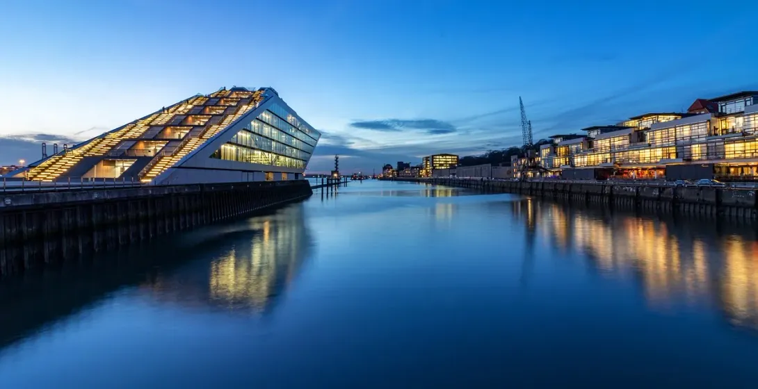 The Elbe Philharmonic Hall in Hamburg, Germany, at twilight, reflecting in the harbor.