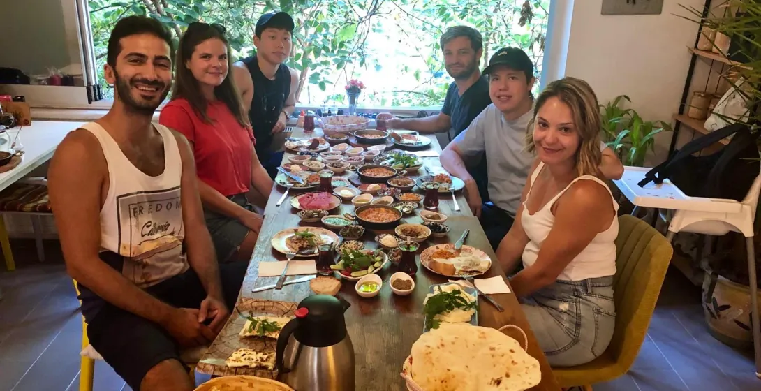 Happy tourists enjoying a delicious Turkish breakfast together in Istanbul.