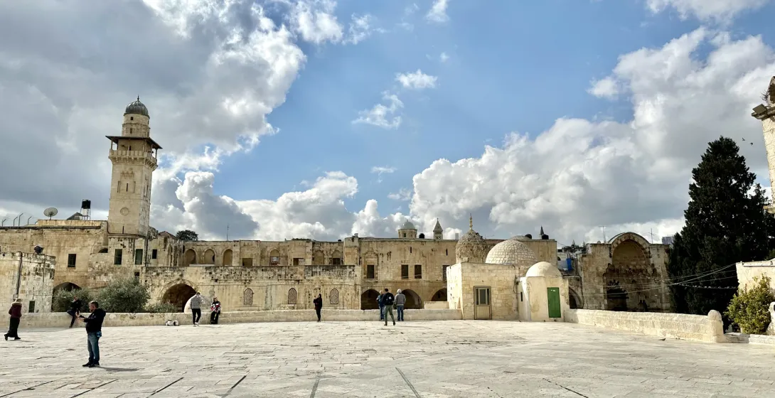 Tourists exploring the serene courtyard of the Temple Mount in Jerusalem.