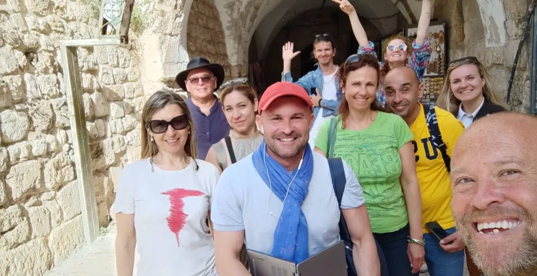 Happy tourists on a guided tour in Jerusalem's Old City.