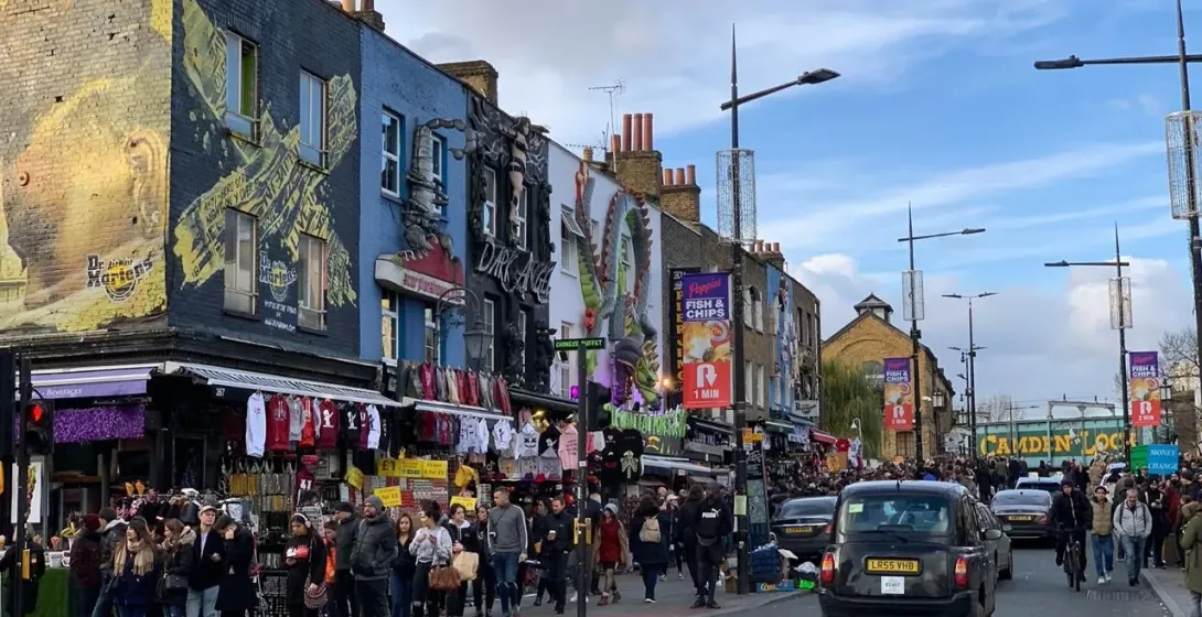 Bustling Camden Market in London, England, showcasing vibrant street art and diverse shops.