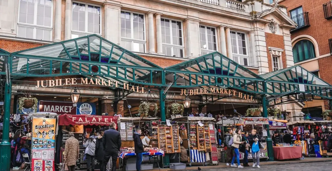 Jubilee Market Hall in London, England, bustling with tourists and vendors.