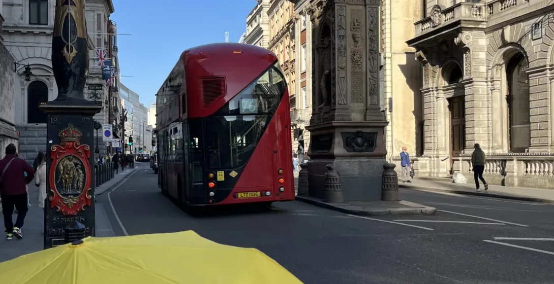 A yellow umbrella with 'Walkative!' on a London street.