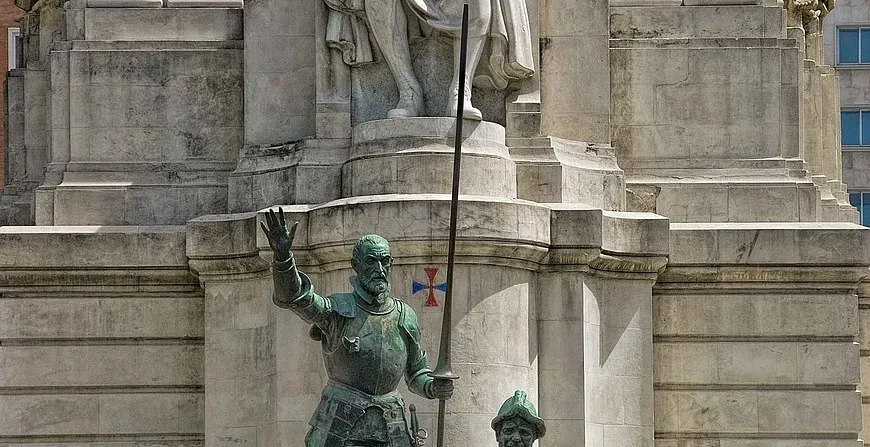 The magnificent Cervantes Monument in Madrid, featuring statues of Cervantes, Don Quixote, and Sancho Panza.