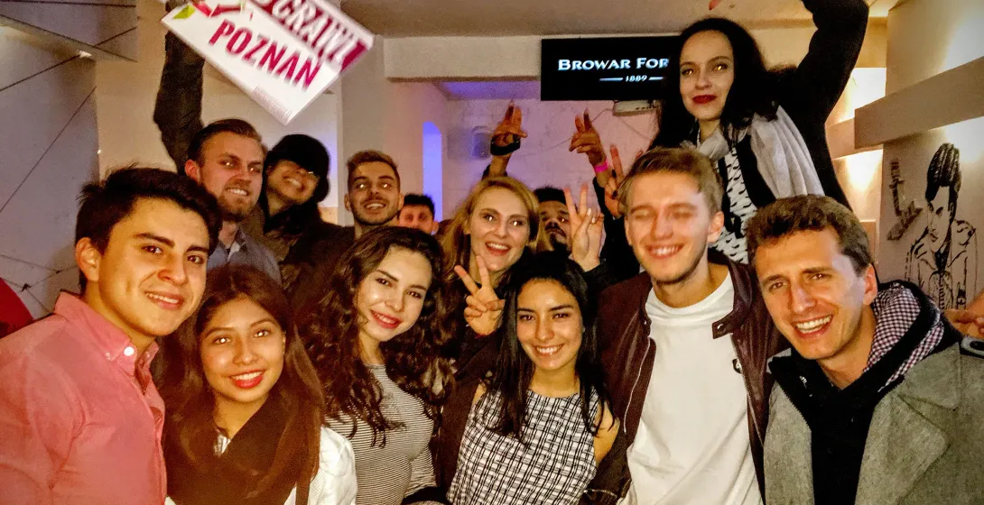 Happy tour group enjoying a pub crawl in Poznan, Poland.