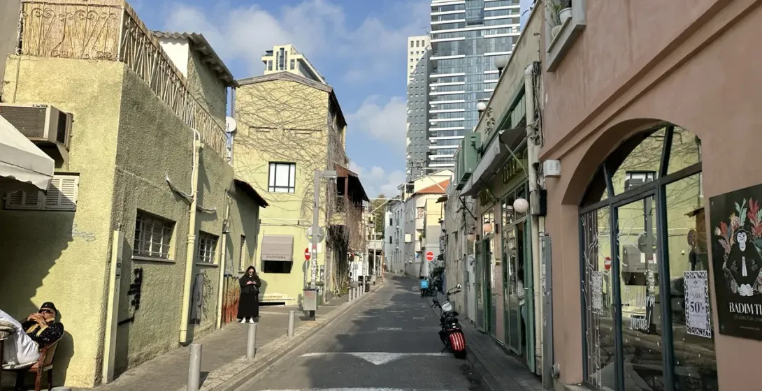 Peaceful street scene in Tel Aviv, Israel, showcasing charming architecture and local businesses.