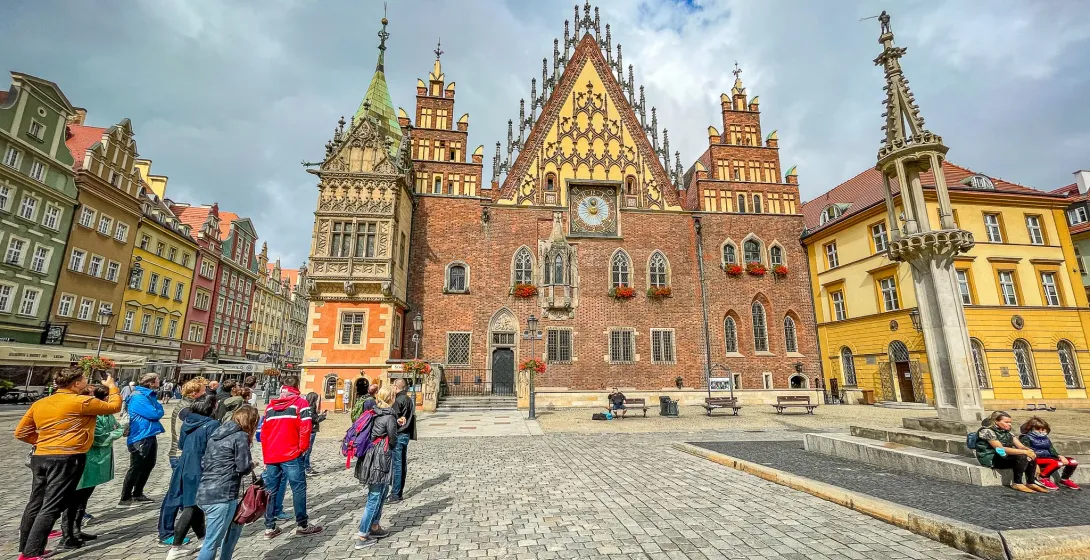 Tour group admiring the Old Town Hall in Wrocław's Market Square.
