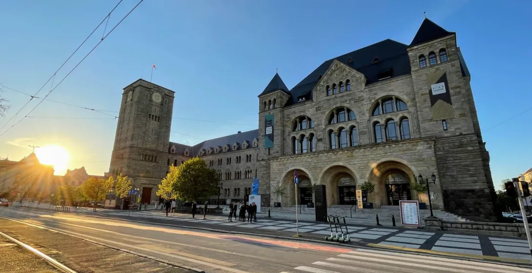 Tourists enjoying a free Walkative! tour in Wrocław, Poland, admiring the Wrocław University of Science and Technology.