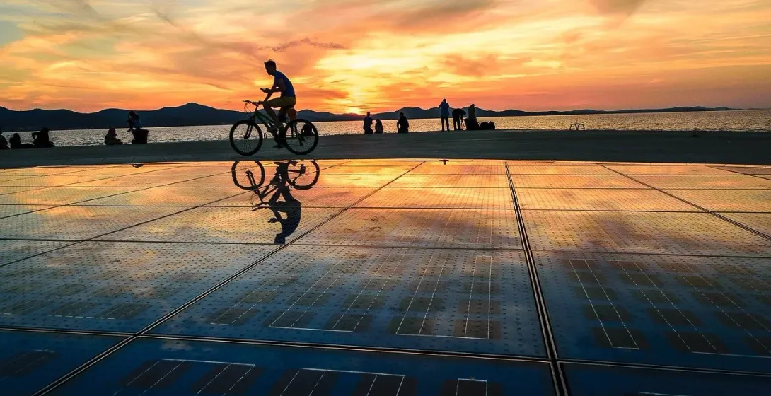 Cyclist at sunset on Greeting to the Sun, Zadar