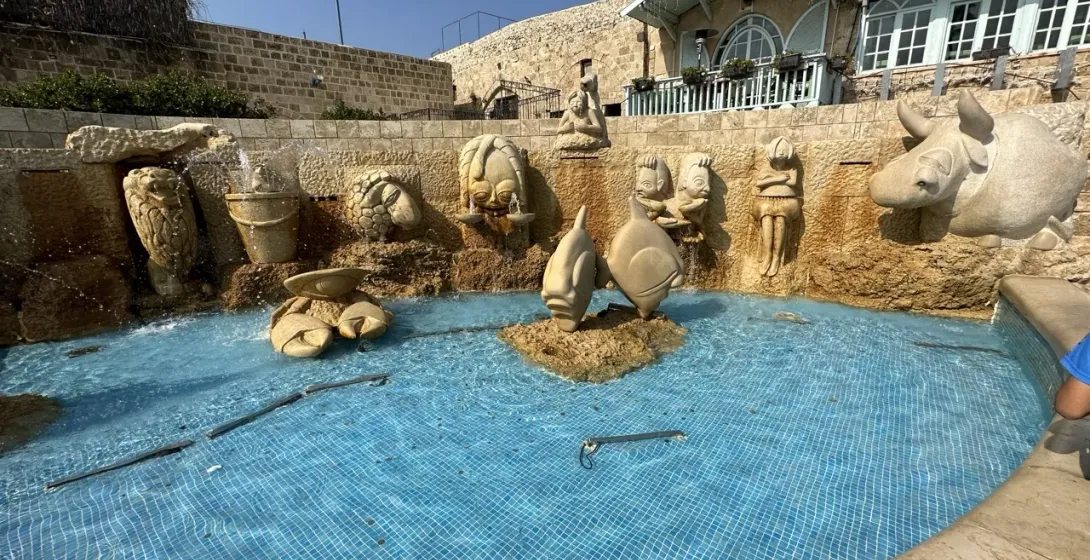 Whimsical fountain with sculpted figures, a charming travel destination.
