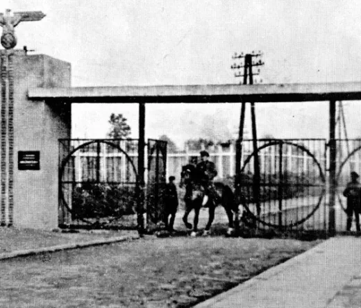 Historical gate with a figure on horseback.