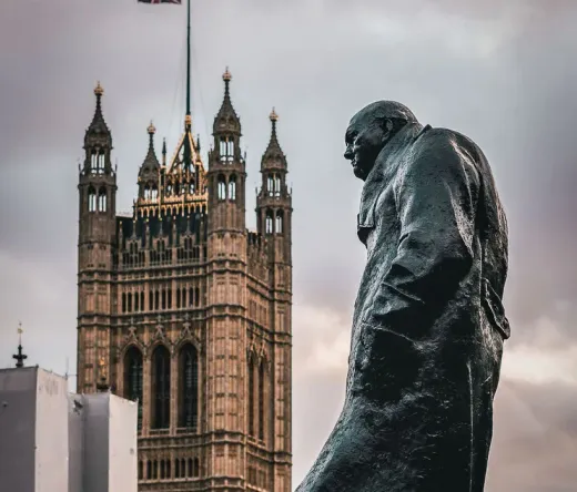 Statue of Winston Churchill with the Palace of Westminster in the background in London.