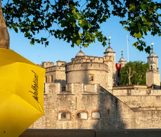 Yellow Walkative umbrella in front of the Tower of London.