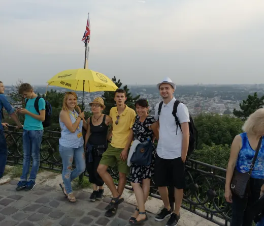 A guided walking tour group in Lviv, Ukraine, enjoying a panoramic city view.