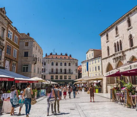 Tourists exploring a beautiful square in Split, Croatia.