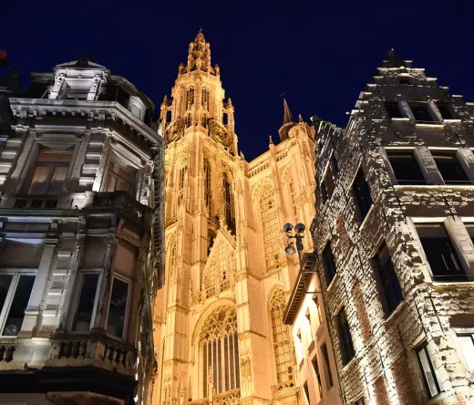 Antwerp's Our Lady's Cathedral illuminated at night during a Dark Stories tour.
