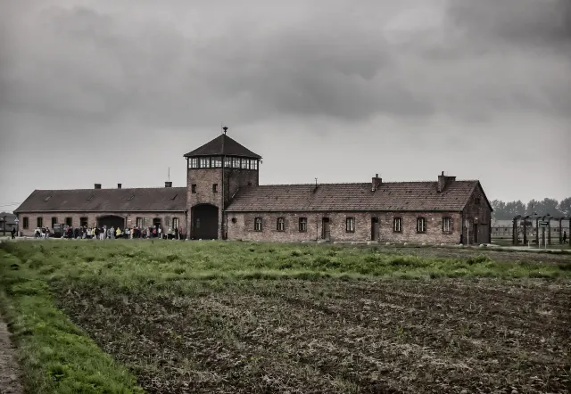 A guided tour group at the Auschwitz-Birkenau Memorial and Museum.