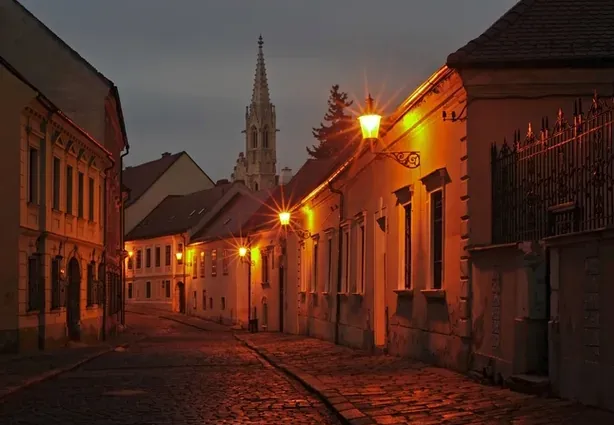 Spooky Bratislava tour: A charming cobblestone street at night.