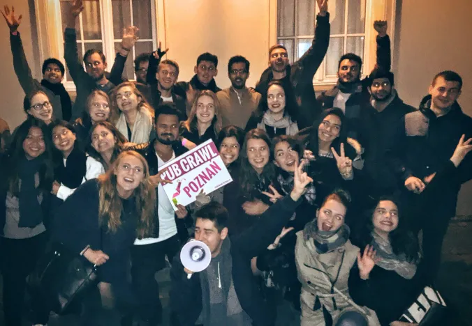 A large group enjoys a pub crawl tour in Poznan, Poland.