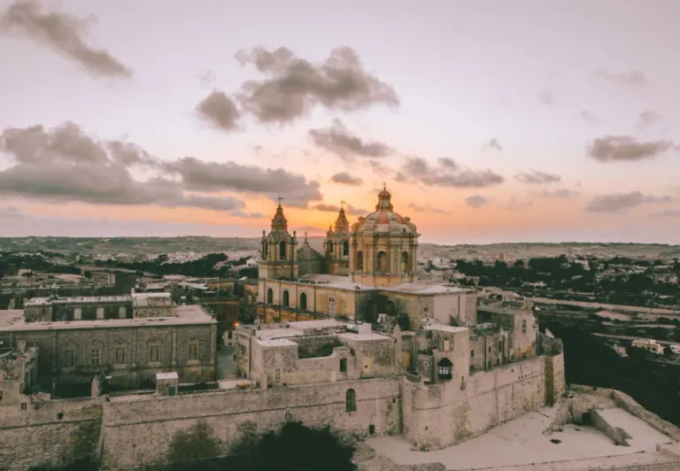 Aerial view of St. Paul's Cathedral in Mdina, Malta at sunset.