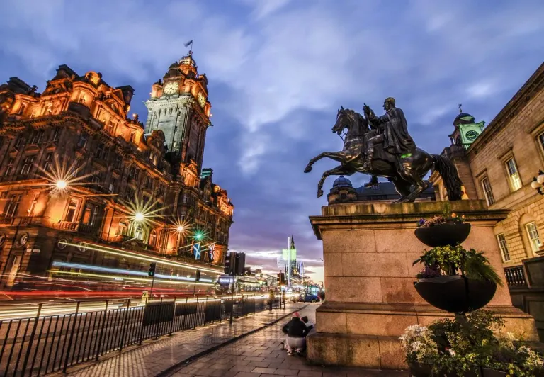Edinburgh Old Town at night: Balmoral Hotel and King George IV statue.