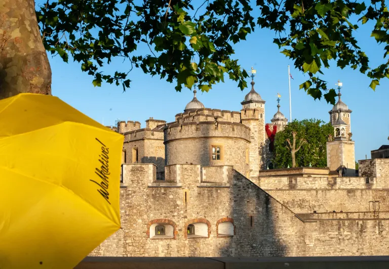 Yellow Walkative umbrella in front of the Tower of London.
