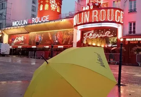 Walkative! tour guide umbrella in front of the Moulin Rouge in Paris.