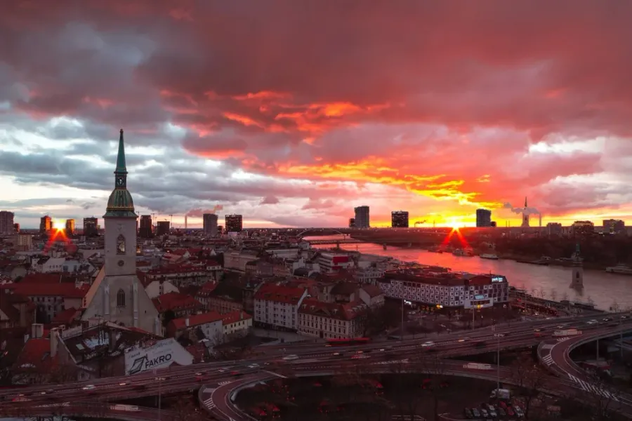 Stunning sunset over Bratislava, Slovakia, showcasing the city's skyline and St. Martin's Cathedral.