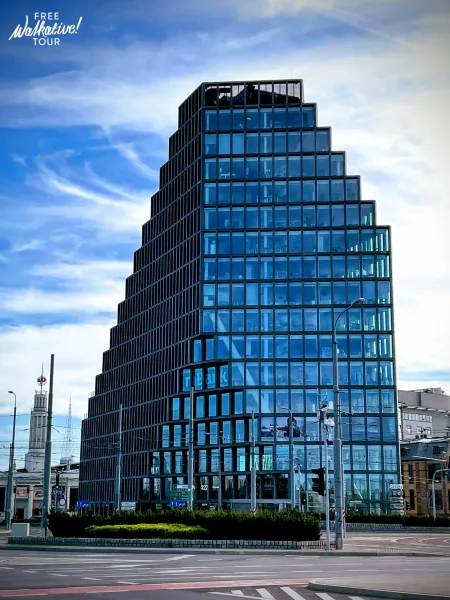 A modern pyramid-shaped building in a German city, part of a free walking tour.