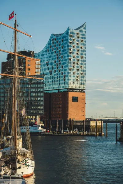 The Elbphilharmonie in Hamburg, Germany, with a sailing ship in the foreground.