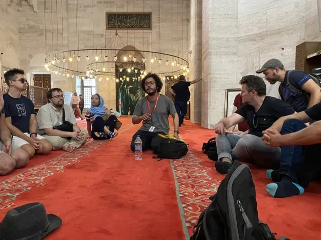 Guided tour group in a historical Istanbul mosque.