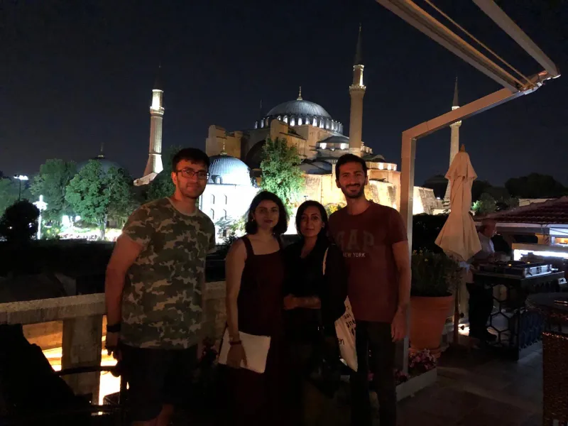Tourists enjoying a night view of the Hagia Sophia in Istanbul.